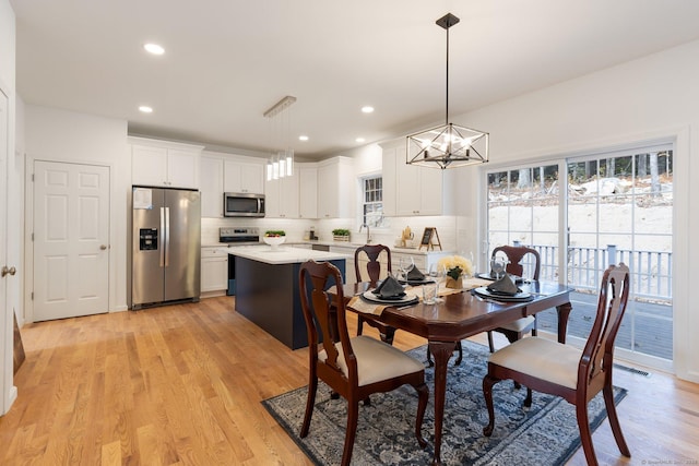 807 Pucker St, Coventry, CT 06238 - dining room with light wood finished floors, a chandelier, and recessed lighting