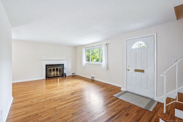 10 John Smith Dr, West Hartford, CT 06107 - foyer featuring light wood finished floors and a fireplace with flush hearth