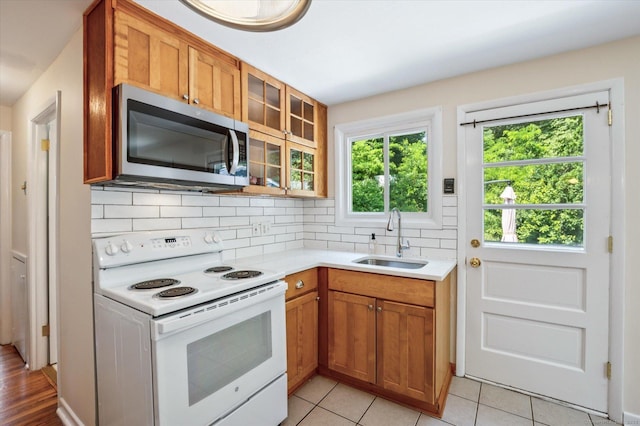 10 John Smith Dr, West Hartford, CT 06107 - kitchen featuring white range with electric cooktop, stainless steel microwave, light countertops, and tasteful backsplash
