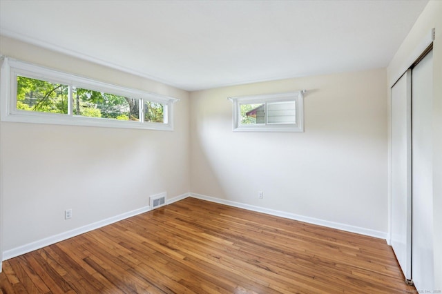 10 John Smith Dr, West Hartford, CT 06107 - unfurnished bedroom featuring wood finished floors and a closet
