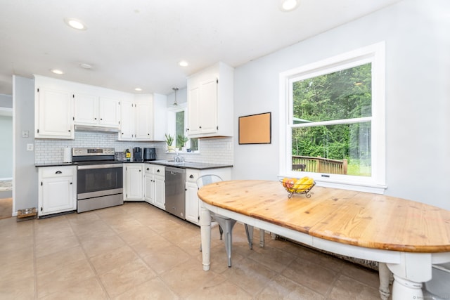 55 Charles Mary Dr, East Hampton, CT 06424 - kitchen featuring stainless steel appliances, dark countertops, tasteful backsplash, white cabinetry, and recessed lighting