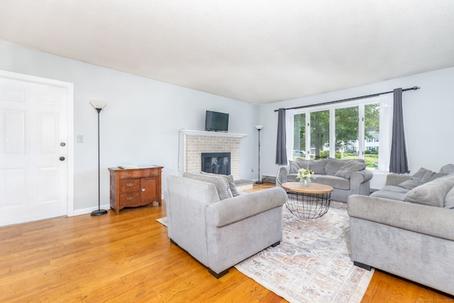 55 Charles Mary Dr, East Hampton, CT 06424 - living area with light wood-type flooring and a brick fireplace