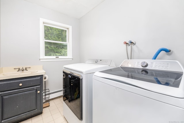 55 Charles Mary Dr, East Hampton, CT 06424 - laundry room with washer and clothes dryer, baseboard heating, light tile patterned flooring, and cabinet space