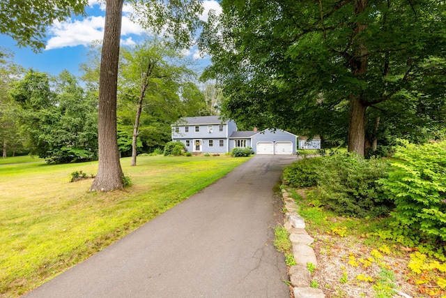 55 Charles Mary Dr, East Hampton, CT 06424 - colonial house featuring driveway, a front yard, an attached garage, and view of scattered trees