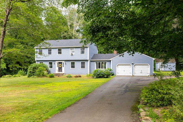 55 Charles Mary Dr, East Hampton, CT 06424 - colonial home with a garage, asphalt driveway, a front lawn, and a chimney