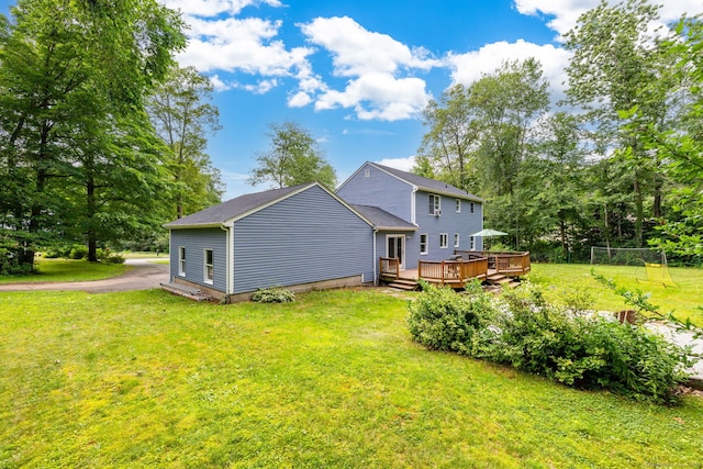 55 Charles Mary Dr, East Hampton, CT 06424 - back of house with a wooden deck, a lawn, and view of scattered trees