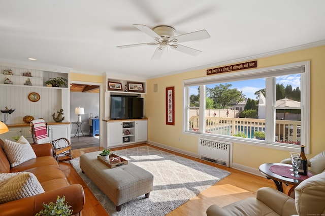 317 Victoria Lawn, Stratford, CT 06615 - living room featuring radiator heating unit, ornamental molding, a ceiling fan, and light wood-style flooring