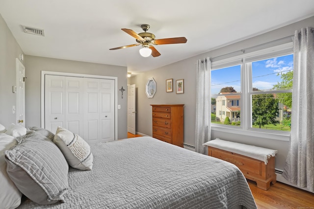 317 Victoria Lawn, Stratford, CT 06615 - bedroom featuring a closet, light wood-type flooring, a ceiling fan, and a baseboard heating unit