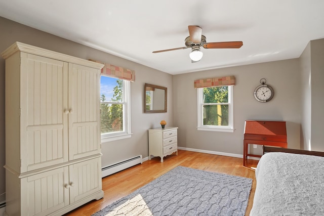 317 Victoria Lawn, Stratford, CT 06615 - bedroom with a baseboard radiator, multiple windows, light wood-type flooring, and a ceiling fan