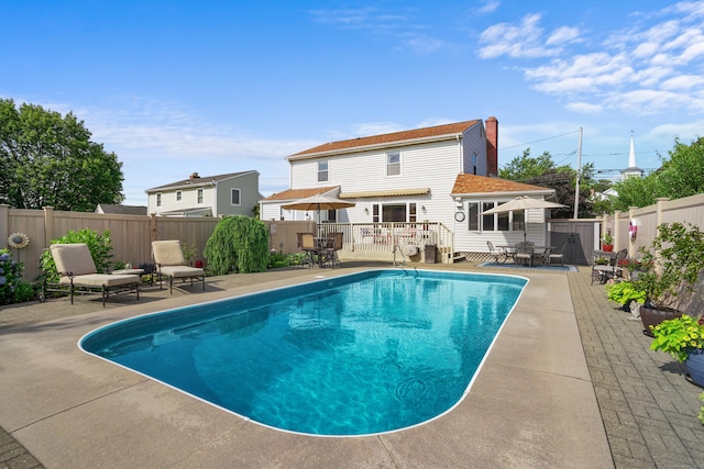 317 Victoria Lawn, Stratford, CT 06615 - view of pool featuring outdoor dining space, a wooden deck, a fenced backyard, and a patio