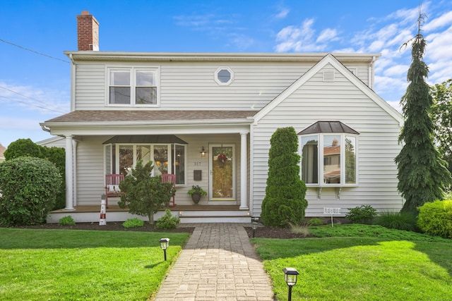 317 Victoria Lawn, Stratford, CT 06615 - view of front of house featuring covered porch, a chimney, and a front lawn