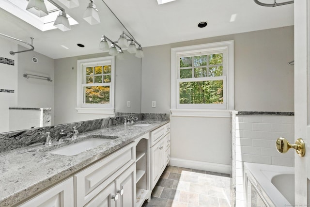 91 Fox Run Rd, New Canaan, CT 06840 - bathroom with a skylight, double vanity, a bath, and a shower