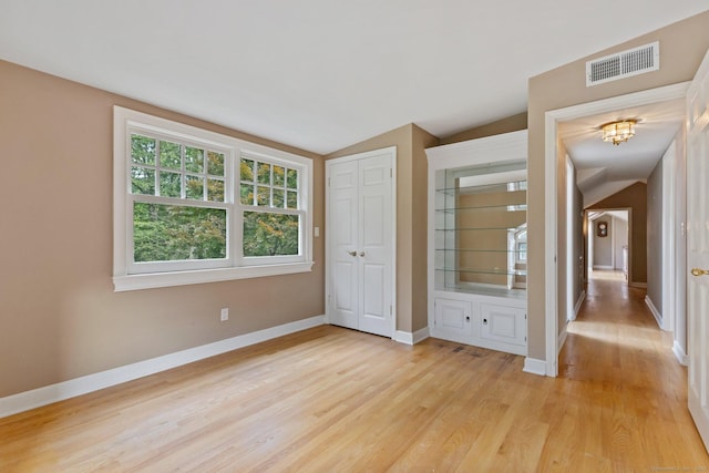 91 Fox Run Rd, New Canaan, CT 06840 - unfurnished bedroom featuring light wood-style floors, a chandelier, vaulted ceiling, and a closet