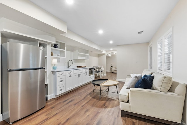 601 Old Stamford Rd, New Canaan, CT 06840 - living room featuring recessed lighting, wood finished floors, arched walkways, and wet bar