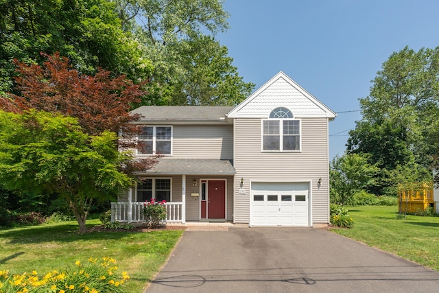 46 Pleasant Ave, Berlin, CT 06037 - view of front of home with covered porch, driveway, a front yard, and a garage