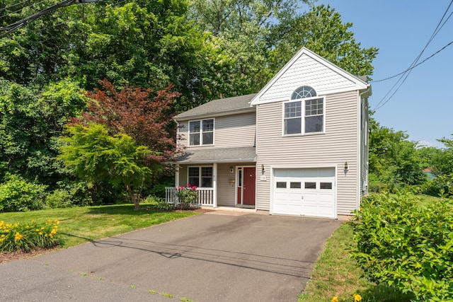46 Pleasant Ave, Berlin, CT 06037 - view of front of house featuring covered porch, asphalt driveway, a front lawn, and a garage