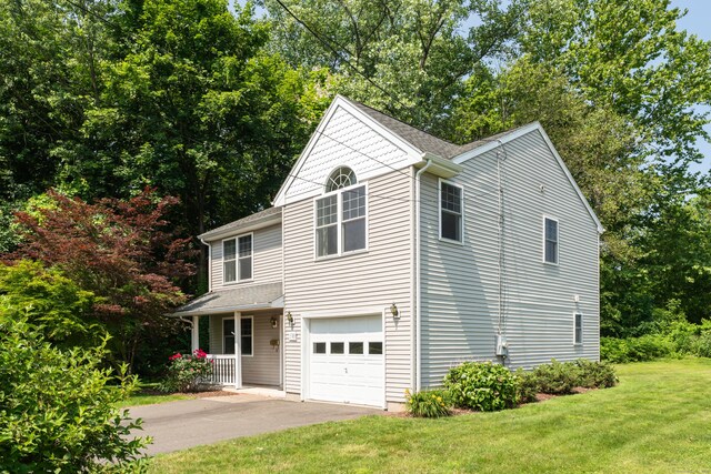 46 Pleasant Ave, Berlin, CT 06037 - view of front of home with a porch, a front lawn, a garage, and driveway