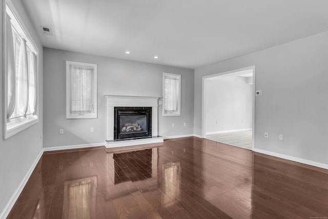 46 Pleasant Ave, Berlin, CT 06037 - unfurnished living room featuring a glass covered fireplace, recessed lighting, and wood finished floors