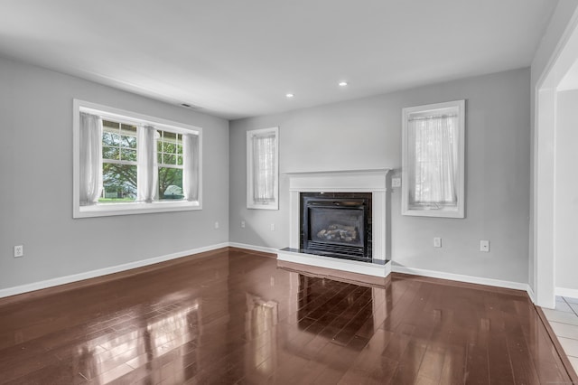 46 Pleasant Ave, Berlin, CT 06037 - unfurnished living room featuring a glass covered fireplace, recessed lighting, and wood finished floors