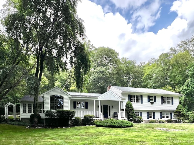 262 Linden Tree Rd, Wilton, CT 06897 - tri-level home featuring a porch, a front lawn, and a chimney