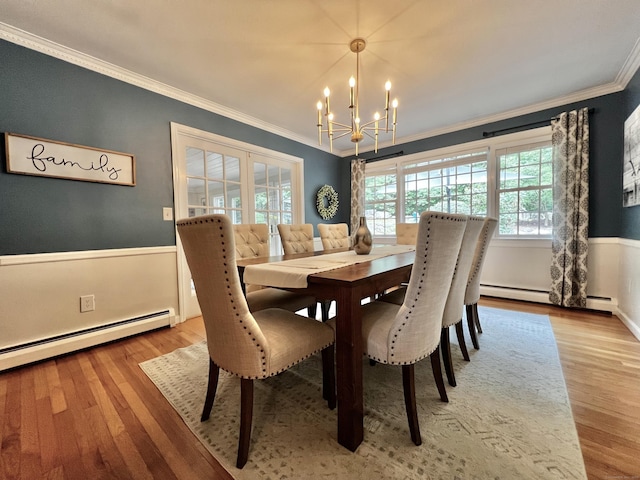 262 Linden Tree Rd, Wilton, CT 06897 - dining space with a chandelier, crown molding, a baseboard heating unit, wood finished floors, and wainscoting