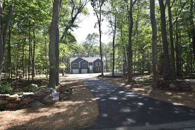 152 Buff Cap Rd, Tolland, CT 06084 - view of front facade with asphalt driveway and a forest view