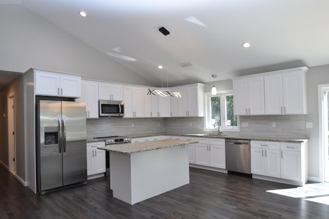 152 Buff Cap Rd, Tolland, CT 06084 - kitchen featuring appliances with stainless steel finishes, white cabinetry, vaulted ceiling, backsplash, and dark wood finished floors