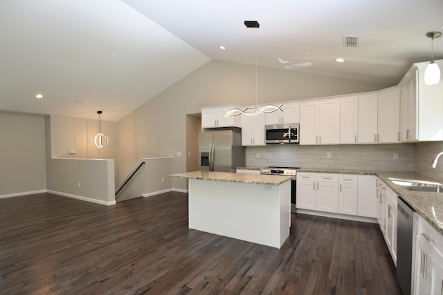 152 Buff Cap Rd, Tolland, CT 06084 - kitchen featuring stainless steel appliances, lofted ceiling, white cabinetry, a center island, and backsplash