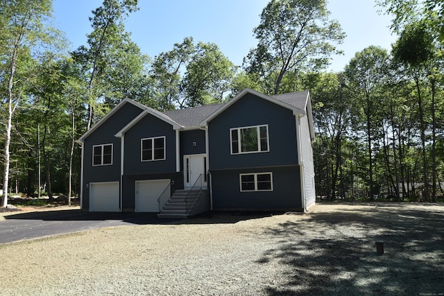 152 Buff Cap Rd, Tolland, CT 06084 - bi-level home featuring an attached garage and driveway