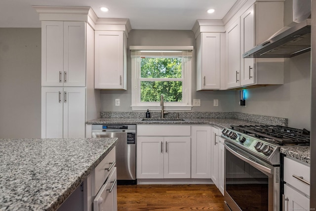 15 Rosemary Ln, Guilford, CT 06437 - kitchen featuring wall chimney exhaust hood, appliances with stainless steel finishes, recessed lighting, light stone countertops, and white cabinetry