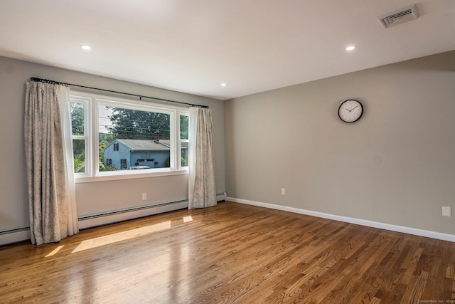 15 Rosemary Ln, Guilford, CT 06437 - empty room with wood finished floors, recessed lighting, and a baseboard heating unit