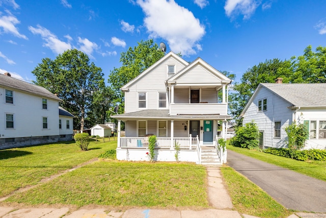 45 William St, East Hartford, CT 06108 - view of front of house with a porch, a front yard, and a balcony