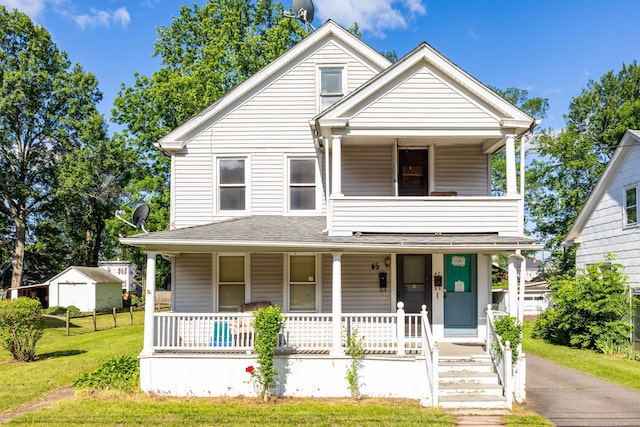45 William St, East Hartford, CT 06108 - view of front of house featuring a porch, a balcony, a front lawn, and roof with shingles
