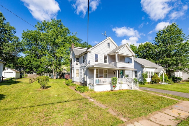 45 William St, East Hartford, CT 06108 - view of front facade featuring a porch, a front lawn, and a chimney