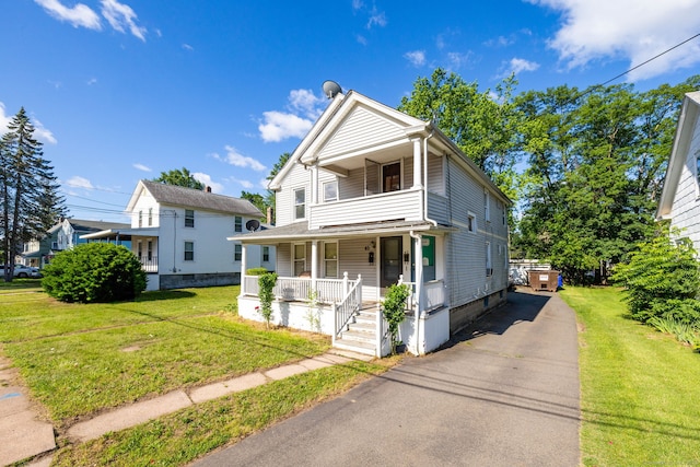 45 William St, East Hartford, CT 06108 - view of front of house featuring a porch, a front lawn, driveway, and a balcony