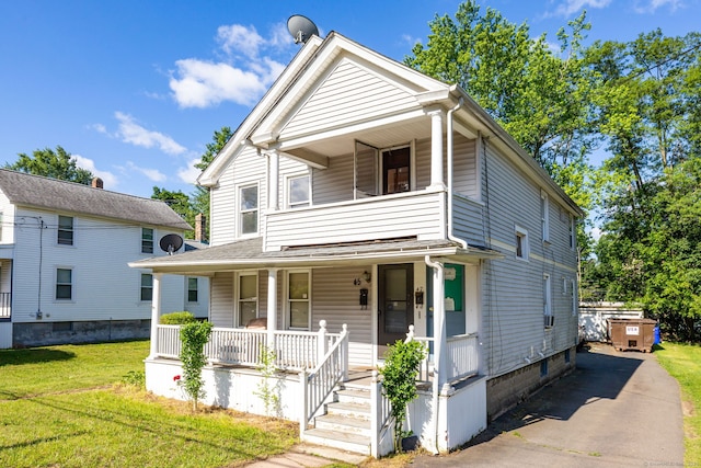 45 William St, East Hartford, CT 06108 - view of front of property with a porch, a balcony, and a front lawn