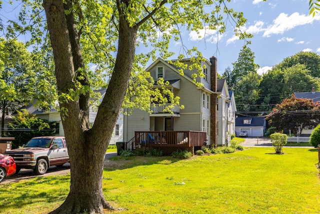 45 William St, East Hartford, CT 06108 - view of side of home with a yard, a deck, a chimney, and a balcony