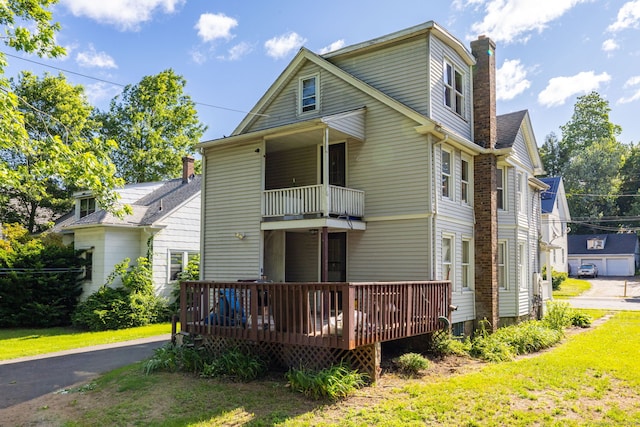 45 William St, East Hartford, CT 06108 - rear view of property featuring a balcony, a chimney, a lawn, and a deck