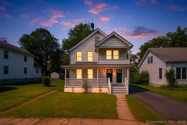 45 William St, East Hartford, CT 06108 - view of front facade featuring covered porch, a front yard, and asphalt driveway