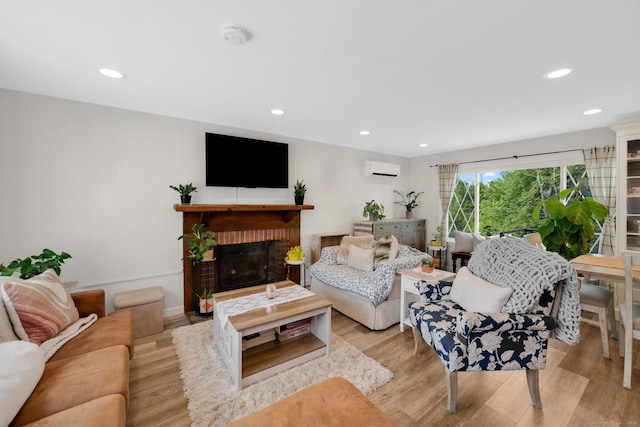 13 Baldwin Hill Rd, Litchfield, CT 06759 - living room with a wall mounted AC, recessed lighting, light wood-style floors, and a brick fireplace