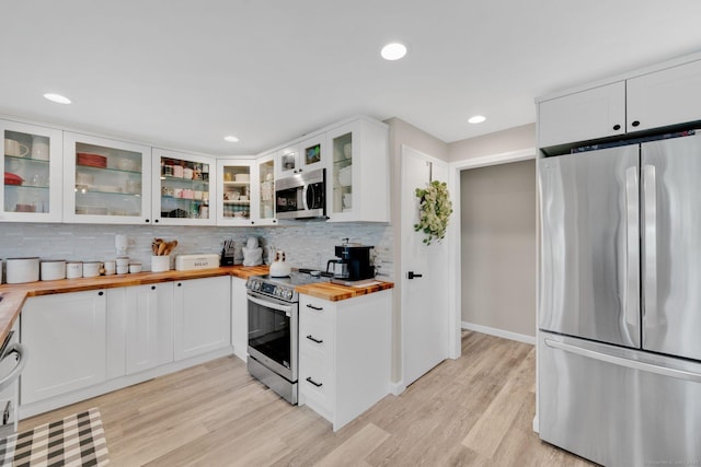 13 Baldwin Hill Rd, Litchfield, CT 06759 - kitchen featuring stainless steel appliances, butcher block counters, decorative backsplash, light wood finished floors, and white cabinets