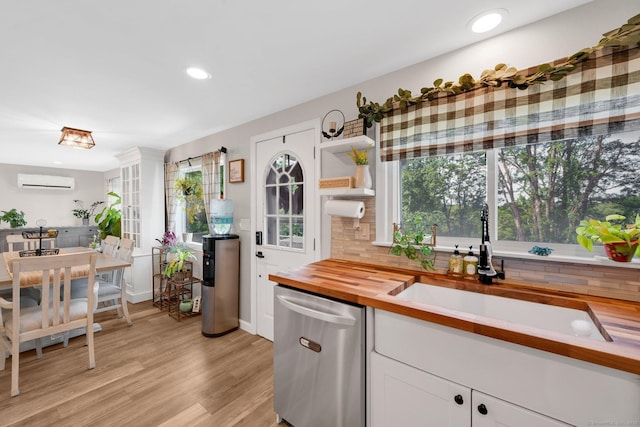 13 Baldwin Hill Rd, Litchfield, CT 06759 - kitchen featuring dishwasher, butcher block counters, an AC wall unit, decorative backsplash, and white cabinetry