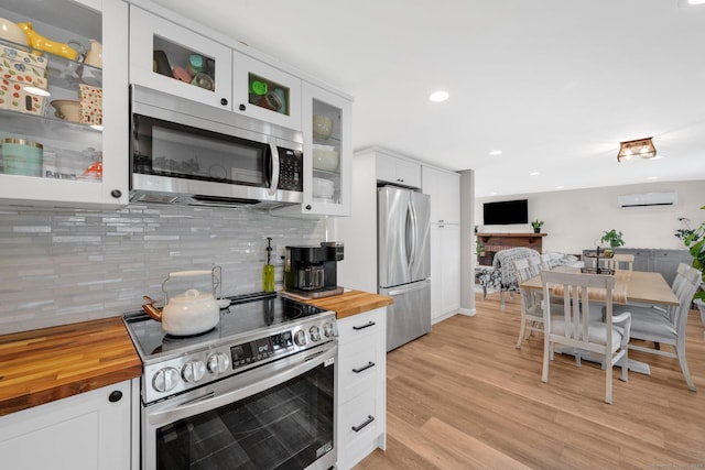13 Baldwin Hill Rd, Litchfield, CT 06759 - kitchen with butcher block counters, appliances with stainless steel finishes, a wall unit AC, white cabinetry, and recessed lighting