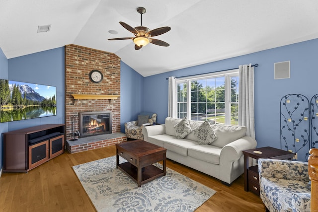 8 Barbara Ln, Southington, CT 06479 - living area with ceiling fan, lofted ceiling, wood finished floors, and a brick fireplace