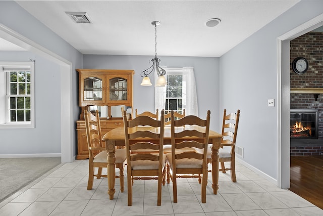 8 Barbara Ln, Southington, CT 06479 - dining area with a brick fireplace and light tile patterned floors