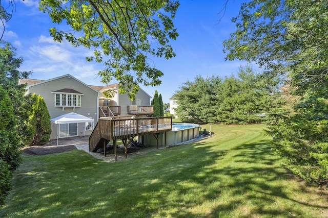 8 Barbara Ln, Southington, CT 06479 - rear view of property featuring a wooden deck, an outdoor pool, a yard, and stairs