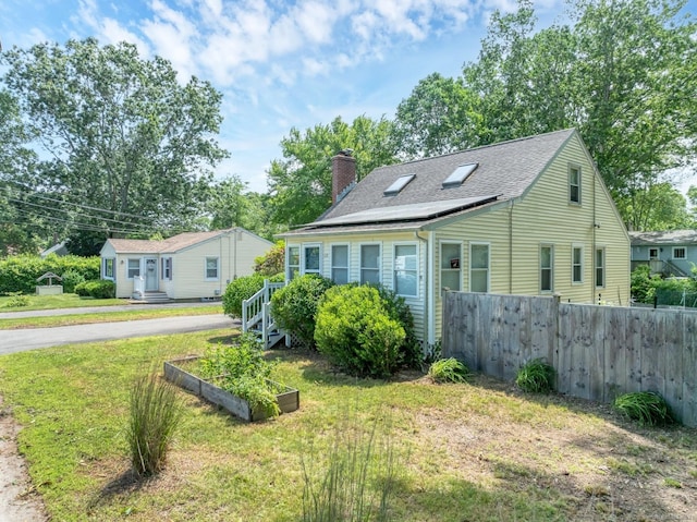 15 Hawks Nest Rd, Old Lyme, CT 06371 - view of front of house with a chimney, a garden, and roof with shingles