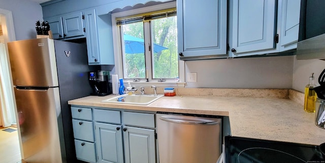 145 Brighton Cir, Windsor, CT 06095 - kitchen with appliances with stainless steel finishes, light countertops, and blue cabinets