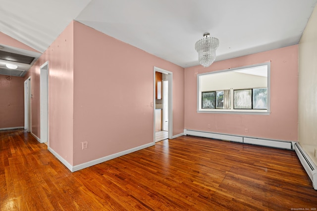 21 Gilbert Hill Rd, Norwalk, CT 06853 - spare room with a baseboard radiator, attic access, wood finished floors, and a chandelier