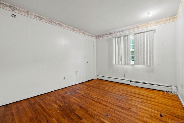 21 Gilbert Hill Rd, Norwalk, CT 06853 - unfurnished room with wood finished floors and a baseboard heating unit
